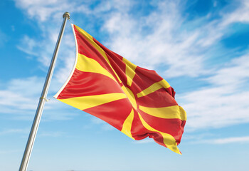 3d rendering Macedonia flag waving in the wind on flagpole. Perspective wiev Macedonia flag waving a blue cloudy sky