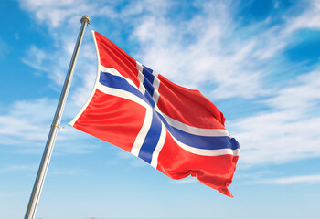 3d rendering Norway flag waving in the wind on flagpole. Perspective view Norway flag waving a blue cloudy sky