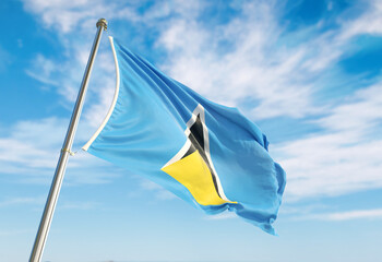 3d rendering Saint Lucia flag waving in the wind on flagpole. Perspective wiev Saint Lucia flag waving a blue cloudy sky