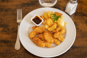 chicken nuggets with fries and barbecue sauce