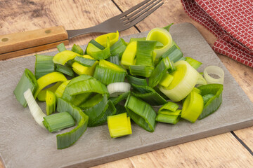 sliced leek on wooden board