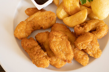 chicken nuggets with fries and barbecue sauce