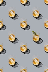 Seamless pattern with glass of whiskey or cocktail with ice. Scotch or bourbon. Rosemary.