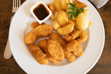 chicken nuggets with fries and barbecue sauce