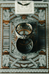 Wedding rings sit on cool backdrop during winter wedding