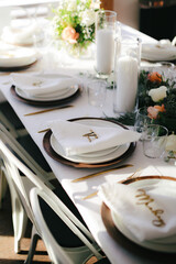 Light falls on dinner table and napkins during small wedding and elopement ceremony.
