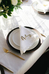 Light falls on dinner table and napkins during small wedding and elopement ceremony.