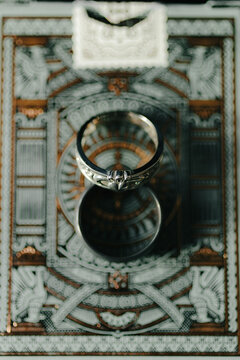 Wedding rings sit on cool backdrop during winter wedding