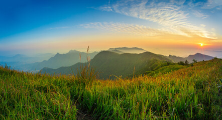 Beautiful landscape nature in morning on peak mountain with sunlight cloud fog and bright blue sky in winter at Phu Chi Fa Forest Park is a famous tourist attraction of Chiang Rai Province, Thailand