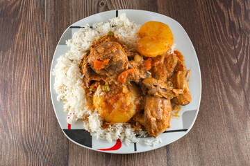 Rice with duck with yellow potatoes, carrot, green peas and white rice