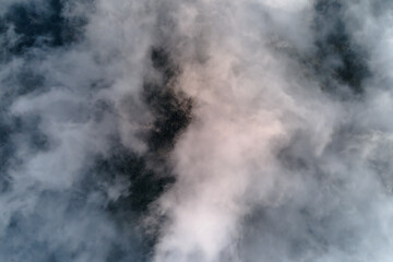 Aerial view from high altitude of earth covered with puffy rainy clouds forming before rainstorm