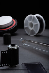 Closeup of 35mm film developing kit with metal film cartridge,a reel and developing tank.
