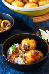 Baked potato stuffed with mince meat and rice with salad. Popular middle eastern food - batata mahshi.