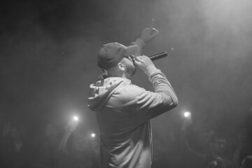 singer and rapper on stage in smoke - obrazy, fototapety, plakaty