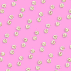 Colorful pattern of white glazed donuts isolated on pink background. Doughnuts. Top view. Flat lay