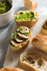Baguette with guacamole, champignons mushrooms and micro green on white plate. Brunch ideas. Vegan...