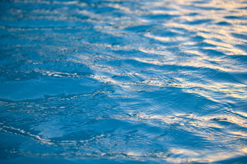 Closeup seascape surface of blue sea water with small ripple waves