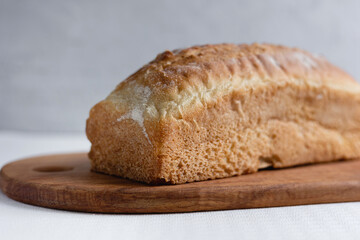 Rye bread on a board on a white tablecloth background