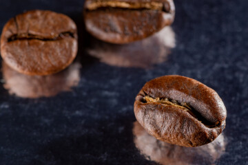 Coffee grains on a dark mirror background