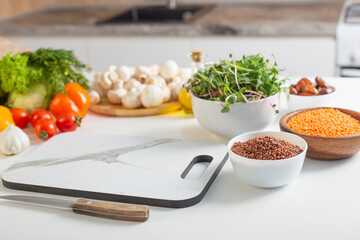 fresh health vegetarian food on white table in kitchen