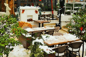 Consequences of a heavy snowfall, the veranda of the restaurant and the tables are covered with a thick layer of snow 