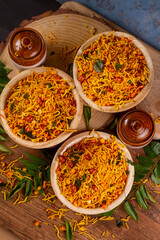 Traditional indian deep fried salty dish - chivda or mixture or farsan or namkeen made of gram flour and mixed with dry fruits. svouries otherwise called as masala mixture chakna.