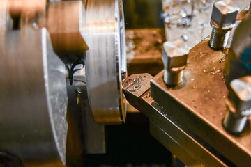 Boring an inner hole with a mechanical cutter on a lathe.