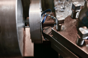 Boring an inner hole with a mechanical cutter on a lathe.