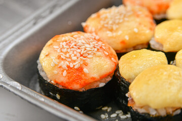 Salmon sushi, seafood sets cold and baked with cheese and sauce.