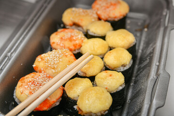 A variety of Japanese sushi sets with shrimp, cheese, crab, salmon and eel wrapped in rolls.
