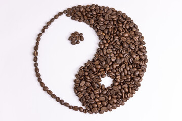 yin yang sign made by coffee beans on white background - obrazy, fototapety, plakaty
