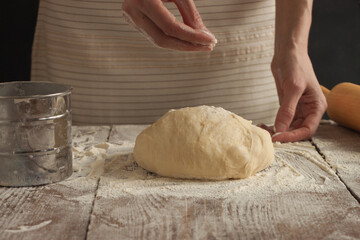 A woman kneads the dough