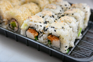 Salmon sushi, seafood sets cold and baked with cheese and sauce.
