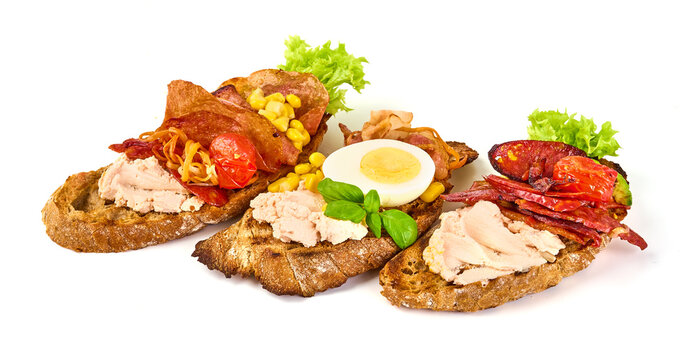 Bruschetta with various toppings, isolated on white background. High resolution image.