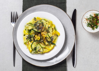 Fried zucchini with melted cheese, herbs and garlic