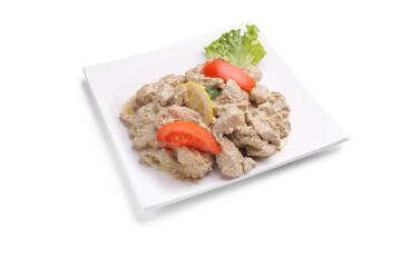 Chicken in white sauce on a plate