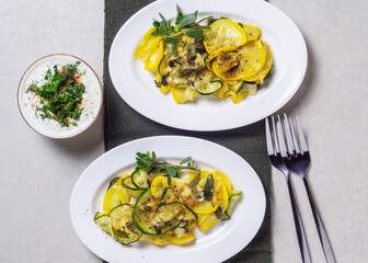 Fried zucchini with melted cheese, garlic and purslane