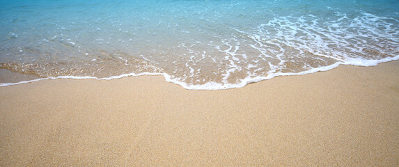 Fototapeta na wymiar Sea wave and sand. Nature horizontal background.