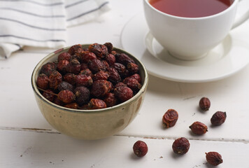 dried dog rose hips rosehip in a bowl on white background