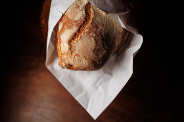 Tasty french bread in paper from bakery