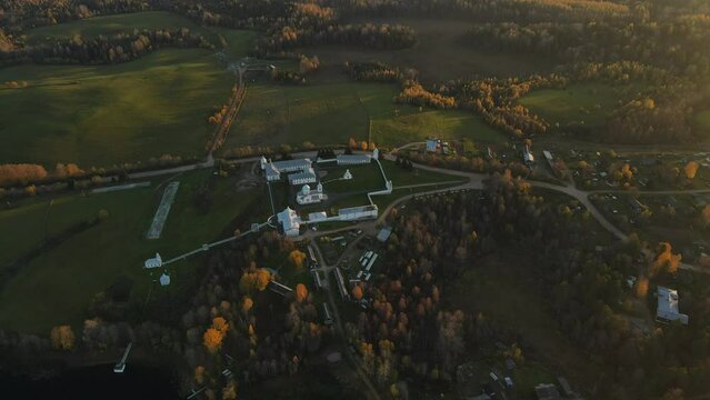 Pokrovsko-Tervenichesky monastery of the Leningrad region on the shore of the lake. Video of autumn landscape with a beautiful sunset and an Orthodox convent.