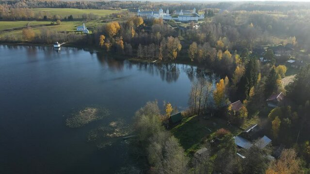 Pokrovsko-Tervenichesky monastery of the Leningrad region on the shore of the lake. Video of autumn landscape with a beautiful sunset and an Orthodox convent.
