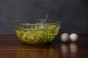 Preparing of courgette roll with ham and bacon and cheese with potatoes