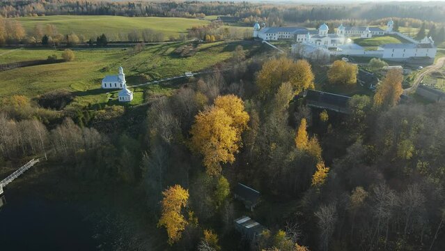 Pokrovsko-Tervenichesky monastery of the Leningrad region on the shore of the lake. Video of autumn landscape with a beautiful sunset and an Orthodox convent.