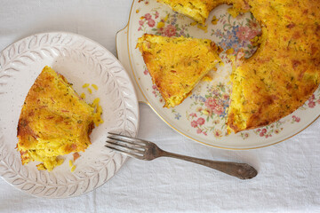 Slice of baked timbale of yellow rice with turmeric and saffron.