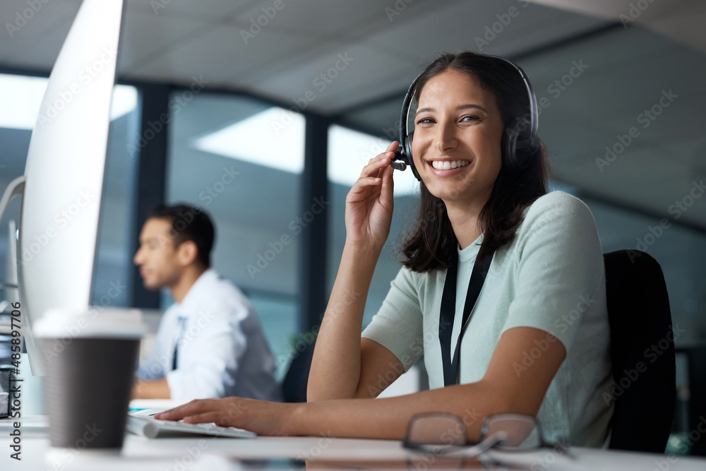 Poster we put quality over quantity. portrait of a young woman using a headset and computer in a modern off