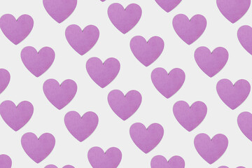 Pattern made of pastel purple heart shape on bright white background. Element of pure love. Minimal valentines concept. Romantic wallpaper idea.