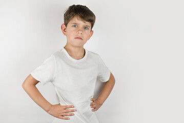 Young boy with emotions of sadness, depression on his face. Portrait of a sad boy 6-8 years old on a light background, the boy needs help and hugs from his parents