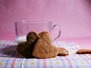 Heart shaped homemade cookies on pink background medium shot