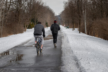People are still using the Vestal Rail Trail even though it is still full of snow, slush, and puddles.  Braving the cold and conditions to get their exercise in.